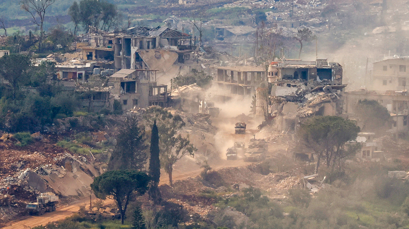 Israeli tanks and military vehicles driving through destroyed houses in southern Lebanon near the border, April 25 2026
