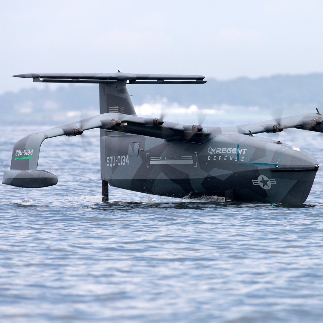 REGENT Squire Seaglider USA-V flying low over ocean wide wingspan electric motors small boat background