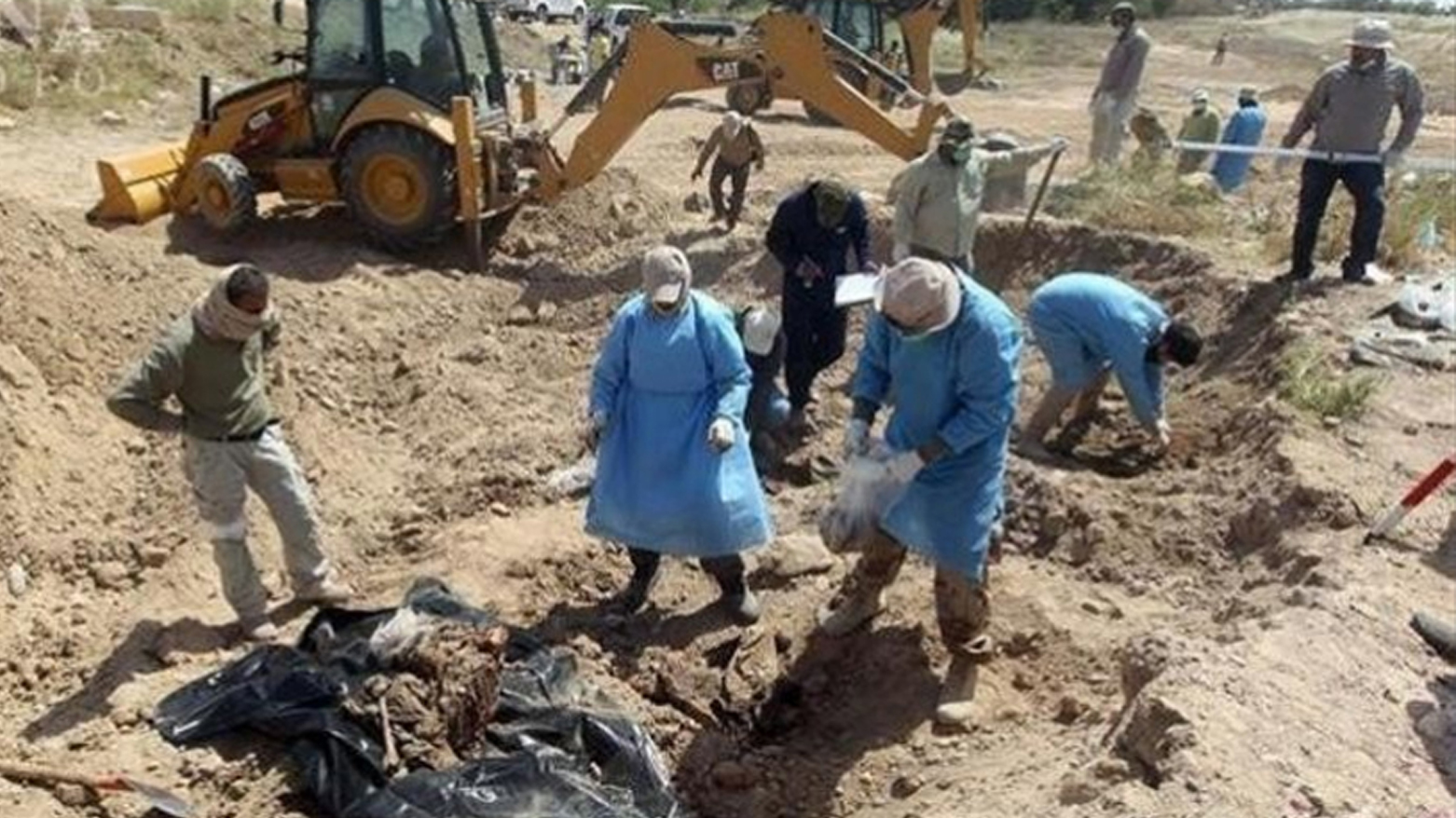 Forensic experts examine the site of the mass grave in Nineveh province believed to contain the remains of Peshmerga fighters executed by ISIS — exhumation is set to begin imminently with DNA testing planned to identify the remains